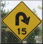 15MPH sign for curve in road