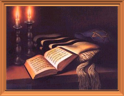 Bible on a table with candles in background